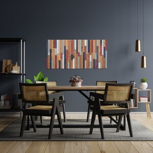 The image shows the reclaimed wood wall sculpture on the wall decorating a modern and elegant living room.