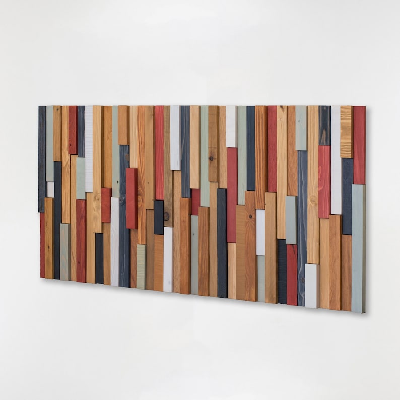 This artwork is made with reclaimed wood. 
It is an elegant and contemporary piece of art and can also be used to decorate the headboard of your bedroom or living room.
The colours I have used are blue-grey, red, white, warm grey and oak.