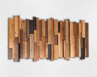 May include: A rectangular wall art piece composed of numerous vertical wooden planks of varying widths and lengths. The planks feature a diverse range of natural wood tones, including light tan, medium brown, dark espresso, and charcoal gray hues.