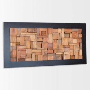 Side image of a decorative artwork. Its dimensions are: 48 x 24 in. The interior has a relief composition of recycled wood pieces of different shapes and tones. Around it there is a narrow area painted in dark brown. It is a modern and original piece
