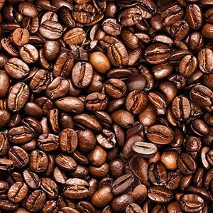 May include: A full-frame shot of roasted coffee beans. The beans are a mix of dark brown and lighter tan shades, with a glossy sheen. The image is tightly packed with beans, creating a textured, seamless pattern.