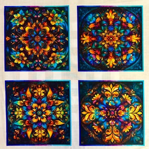 May include: A fabric panel featuring four distinct square designs arranged in a grid. Each square displays a vibrant, symmetrical mandala-like pattern with intricate floral and leaf motifs in shades of deep blue, bright orange, and yellow.