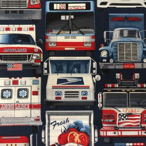 May include: A blue fabric with a pattern of various vehicles, including an ambulance, a fire truck, a mail truck, a bus, and a delivery truck. The vehicles are all red, white, and blue, and they have American flags on them.