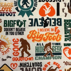 May include: A fabric pattern featuring Bigfoot-themed designs. The design includes Bigfoot silhouettes, footprints, and text such as "Bigfoot," "Hide & Seek," and "Squatchin' Champion." The color palette includes brown, orange, green, and white.