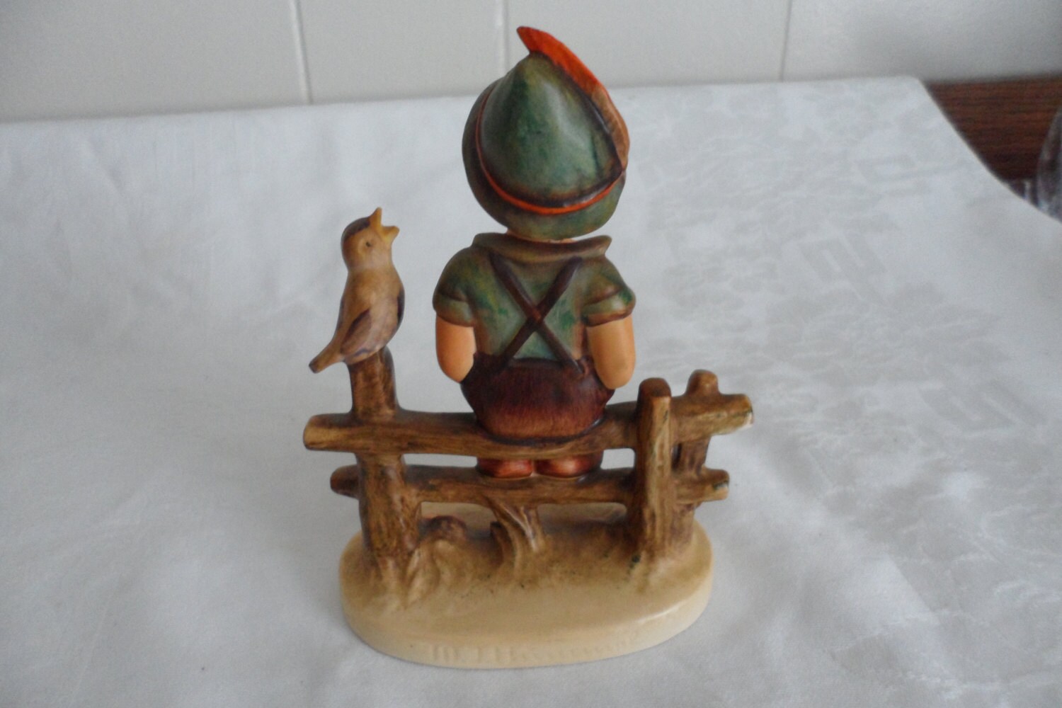 hummel boy on fence with bird