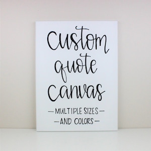 May include: White canvas with black text that reads "Custom quote canvas - Multiple sizes - And colours".