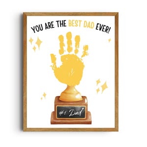 May include: A framed print with a handprint trophy design. The trophy is gold, with a brown base and a black plaque that reads "#1 Dad." The text above says "YOU ARE THE BEST DAD EVER!" with gold star accents.