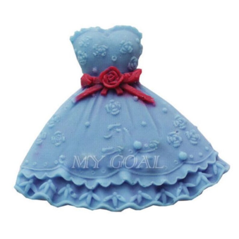 May include: A blue dress cake mould with a red bow and floral details. The mould is made of silicone and is designed to create a cake that looks like a dress.