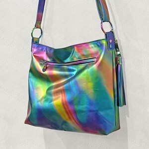 Aurora colourful bright spectral leather bag with outside soft glide zipper pocket and inside slip pockets. Leather tassel clip on, adjustable comfortable leather strap