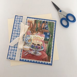 Grazioso biglietto vuoto con coniglio, decorato con decoupage, torta e candeline. Gamma Holly Pond Hill dell'artista Susan Wheeler.
