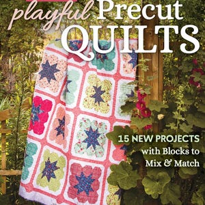 May include: A book titled MORE playful Precut QUILTS by Amanda Niederhauser featuring 15 NEW PROJECTS with Blocks to Mix & Match. The cover displays a quilt with a grid of white-bordered blocks containing colorful floral and star-shaped patterns.