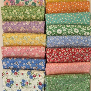 May include: A selection of folded fabric bundles with floral patterns. Colours include yellow, orange, green, blue, red, and pink. The fabrics feature small daisy, rose, and other flower designs. Suitable for quilting or craft projects.