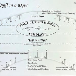 May include: Clear plastic quilting template with the text "SCALLOPS, VINES & WAVES TEMPLATE". It has inch measurements along the edges and is designed for making vines, scallops, and waves on quilts. Includes a companion book.