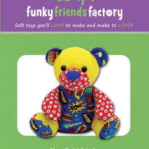 May include: A 12-inch soft toy bear named Ben the Beginner Bear from Funky Friends Factory. The bear features a yellow textured head, a blue nose, and a body covered in comic book-style patterns with words like POW, WOW, and ZOOM in blue, red, and yellow.