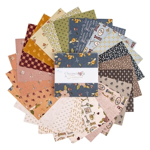 May include: A stack of square fabric swatches arranged in a circular fan pattern. The fabric features various floral, geometric, and vintage-inspired prints in shades of blue, mustard, burgundy, and cream. A white paper band reads Charmed & Treasured.
