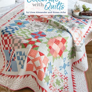May include: A colorful quilt with a variety of patterns and colors, including red, pink, blue, green, and white. The quilt is made up of squares and triangles, and it has a scalloped edge. The quilt is on a bed with a white pillow and a wooden floor. The text "Celebrate with Quilts" is written in a decorative font above the quilt. The text "by Lissa Alexander and Susan Ache" is written below the quilt.