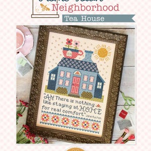 May include: A framed cross-stitch pattern titled Home Town Neighborhood Tea House featuring a blue house with a pink door, a tea cup with flowers on the roof, a yellow sun, and the text: Ah! There is nothing like staying at HOME for real comfort.
