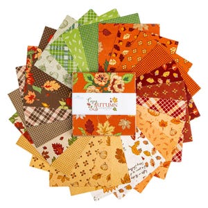 May include: A stack of square fabric swatches arranged in a fan pattern, featuring various autumn-themed prints in orange, brown, green, and cream. A white paper band wraps around the center, printed with the text Cozy Autumn by Sandy Gervais.