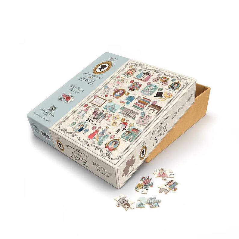 May include: A Jane Austen A to Z 250-piece puzzle. The puzzle box is light blue and white, with illustrations of Jane Austen-themed imagery. Some puzzle pieces are scattered around the box. The box is open, revealing the puzzle pieces inside.