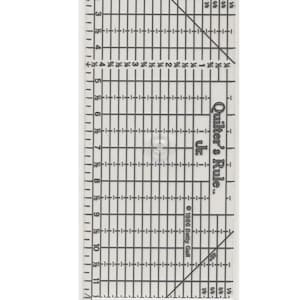 May include: Clear plastic quilting ruler with black grid lines and measurements in inches. The ruler is labeled "Quilter's Rule Jr." and measures 4 1/2" x 14". Includes text "Made in America".