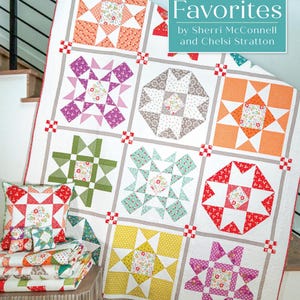May include: A quilt pattern book titled "Family Favorites" by Sherri McConnell and Chelsi Stratton. The book cover features a colorful quilt with a variety of star and geometric patterns. The text "Back to Basics with Sherri and Chelsi!" is at the bottom of the cover.