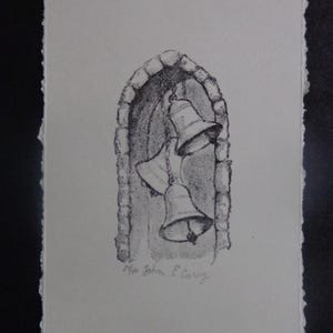 May include: A black and white ink drawing on textured paper featuring two hanging bells inside a stone archway. The artwork is signed John E Carey and numbered 24/40 at the bottom. The paper has a deckled edge and is presented on a dark background.