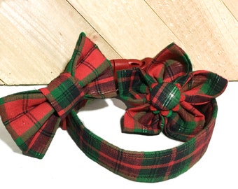 May include: Red and green plaid dog collar with a matching bow tie and flower. The collar has a plastic buckle closure.