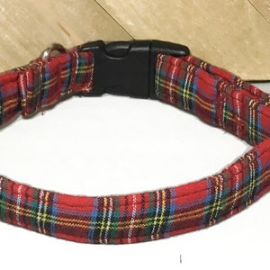May include: Red and green plaid dog collar with a black plastic buckle.