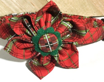 May include: Red and green plaid dog collar with a large green fabric flower with a red and green plaid center.