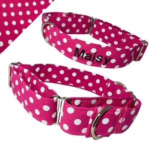 May include: Two pink and white polka dot dog collars with silver hardware. The collar on the top has the name "Maisy" embroidered on it.