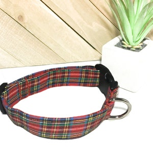 May include: Red, green, and yellow plaid dog collar with a black buckle and silver D-ring.