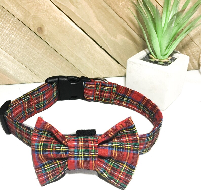 May include: Red and black plaid dog collar with a matching bow tie. The collar has a plastic buckle.