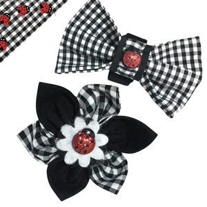 May include: Two black and white gingham fabric hair bows with red ladybug embellishments. One bow is a simple bow, the other is a flower shape.