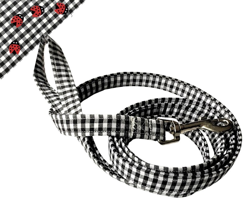 a black and white checkered leash with ladybugs on it