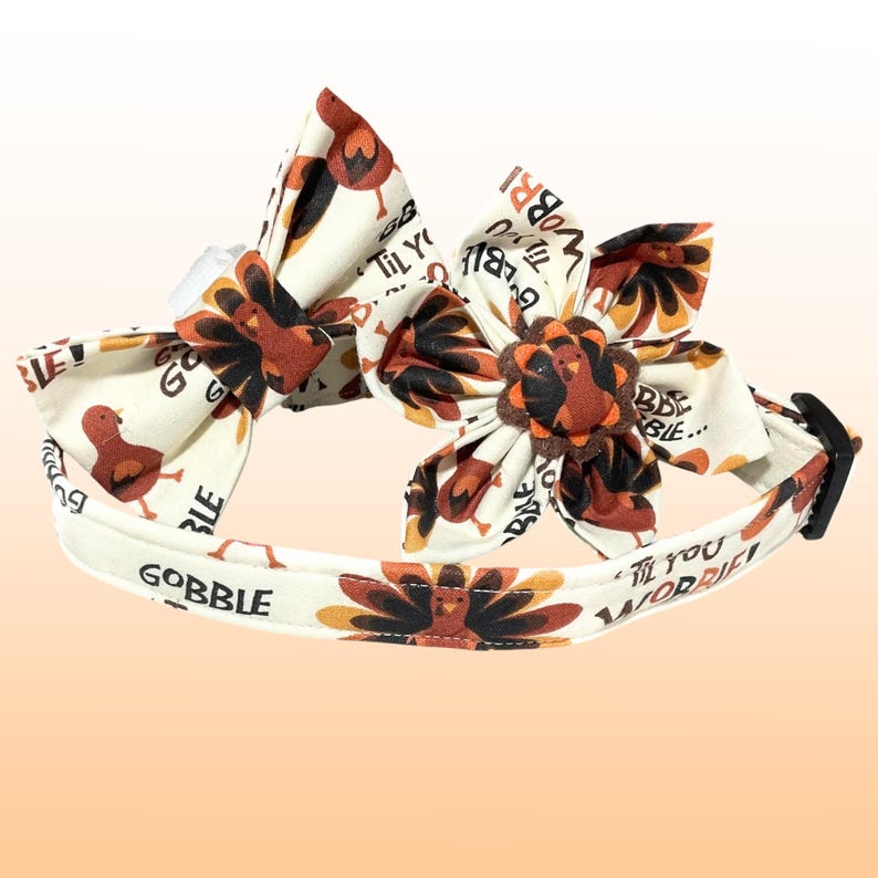 a white headband with a red and orange flower on it