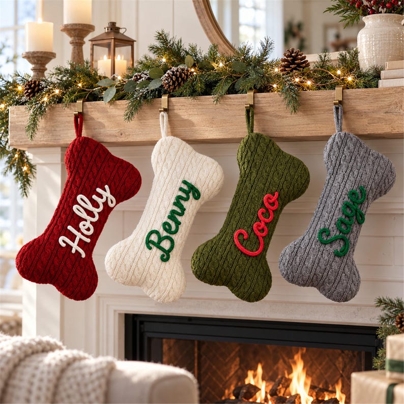 May include: Four bone-shaped Christmas stockings made of cable-knit fabric in red, cream, olive green, and gray. Each stocking features a personalized name embroidered in a contrasting color: Holly in white, Benny in green, Coco in red, and Sage in green.