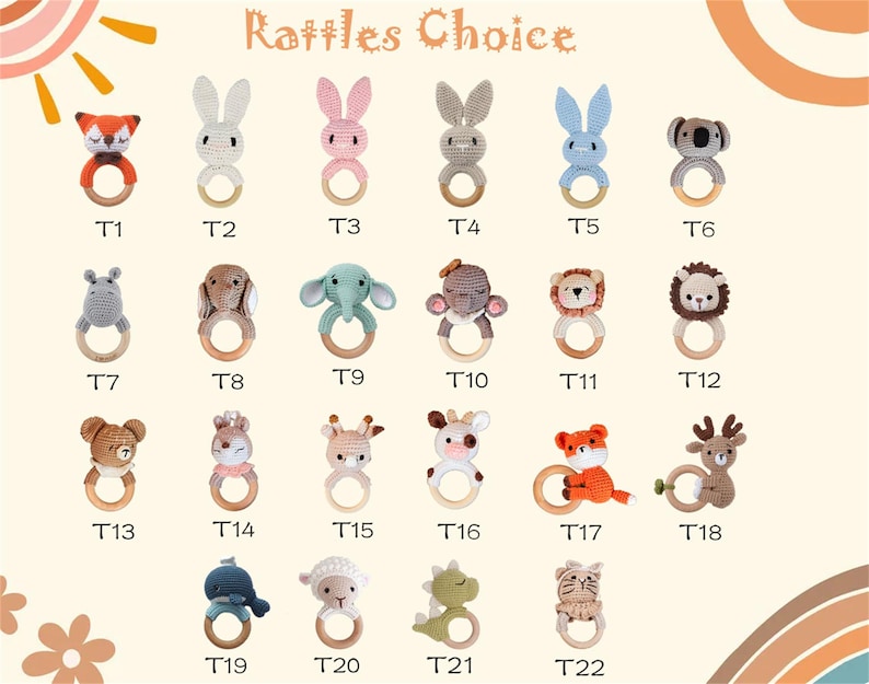 May include: A collection of twenty-two crochet baby rattles in various animal shapes, including a fox, rabbit, koala, and lion. Each rattle features a wooden ring and is labeled with a "T" followed by a number.