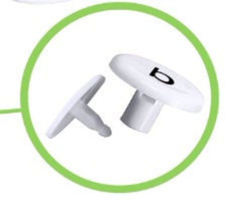 May include: Two white plastic push pins with a black letter 'B' on the top of one pin.