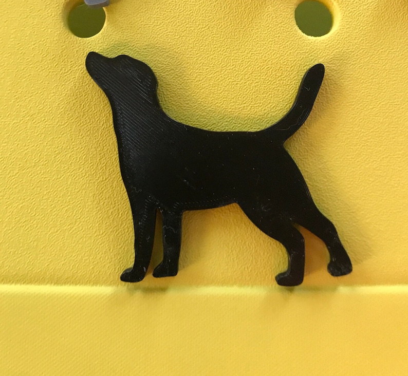 May include: Black silhouette of a dog standing on a yellow background.