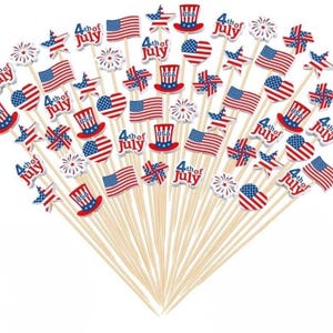 May include: A collection of wooden skewers topped with patriotic decorations. The toppers feature American flags, stars, top hats, and heart shapes in red, white, and blue. The text "4th of July" is also present on some of the toppers.