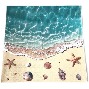 May include: A square paper napkin featuring a beach scene. The top half depicts turquoise water with white foamy waves. The bottom half shows a sandy beach with starfish and seashells.