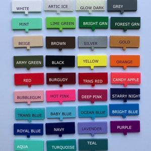May include: A color chart with 24 different colored squares, each with a name written in white text. The colors include white, arctic ice, glow dark, grey, mint, lime green, bright green, forest green, beige, brown, silver, gold, army green, black, yellow, orange, red, burgundy, trans red, candy apple, bubblegum, hot pink, deep pink, starry night, trans blue, baby blue, ocean blue, bright blue, royal blue, navy, lavender, purple, aqua, teal, and turquoise.