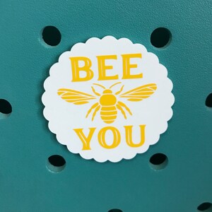 May include: White sticker with a yellow bee and the text "BEE YOU" in yellow letters.