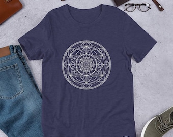 May include: A navy blue t-shirt featuring a white geometric design. The design is a circle with a complex pattern of lines and shapes.