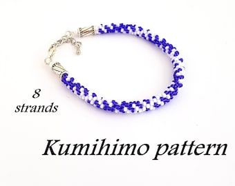 May include: A blue and white beaded bracelet made with the kumihimo technique. The bracelet is made with 8 strands of beads and has a silver clasp. The text "Kumihimo pattern" is written below the bracelet.