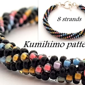 May include: A Kumihimo pattern bracelet with eight strands. The bracelet features a spiral design with black, yellow, pink, blue, and iridescent beads. The bracelet has a silver toggle clasp.