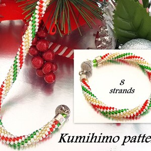 May include: A red, white and green beaded bracelet with a silver clasp. The bracelet is made with 8 strands of beads and is a Kumihimo pattern.