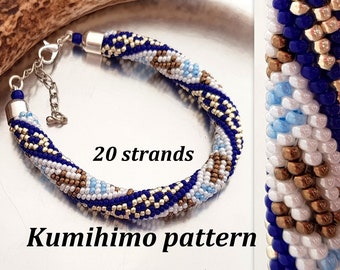 May include: A blue, white, and gold beaded bracelet made with the kumihimo technique. The bracelet is made with 20 strands of beads and has a silver clasp. "Kumihimo pattern" is written below the bracelet.