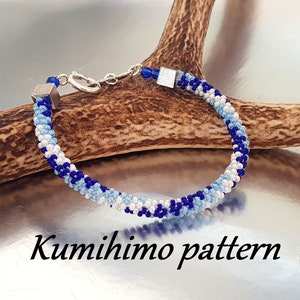May include: A blue, white and silver beaded bracelet with a silver clasp. The bracelet is made using the kumihimo braiding technique. "Kumihimo pattern" is written below the bracelet.
