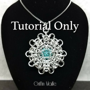 May include: A silver chain necklace with a silver pendant featuring a turquoise gemstone in the center. The pendant is a circular design with a repeating pattern of interlocking rings. The text "Tutorial Only" is displayed above the pendant. The text "Griffin Maille" is displayed below the pendant.